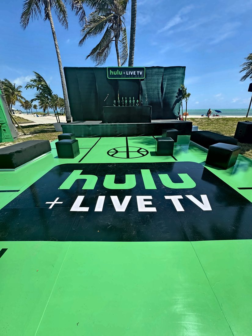 Hulu + Live TV beach activation with a branded court floor and stage